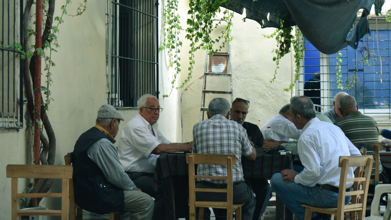 Older men in easy conversation around a table